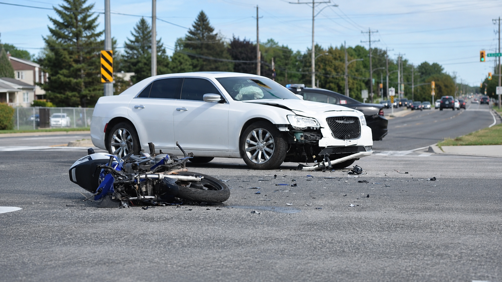 Illustration of a damaged car and motorcycle at an intersection; not a photograph of a collision discussed in this article.